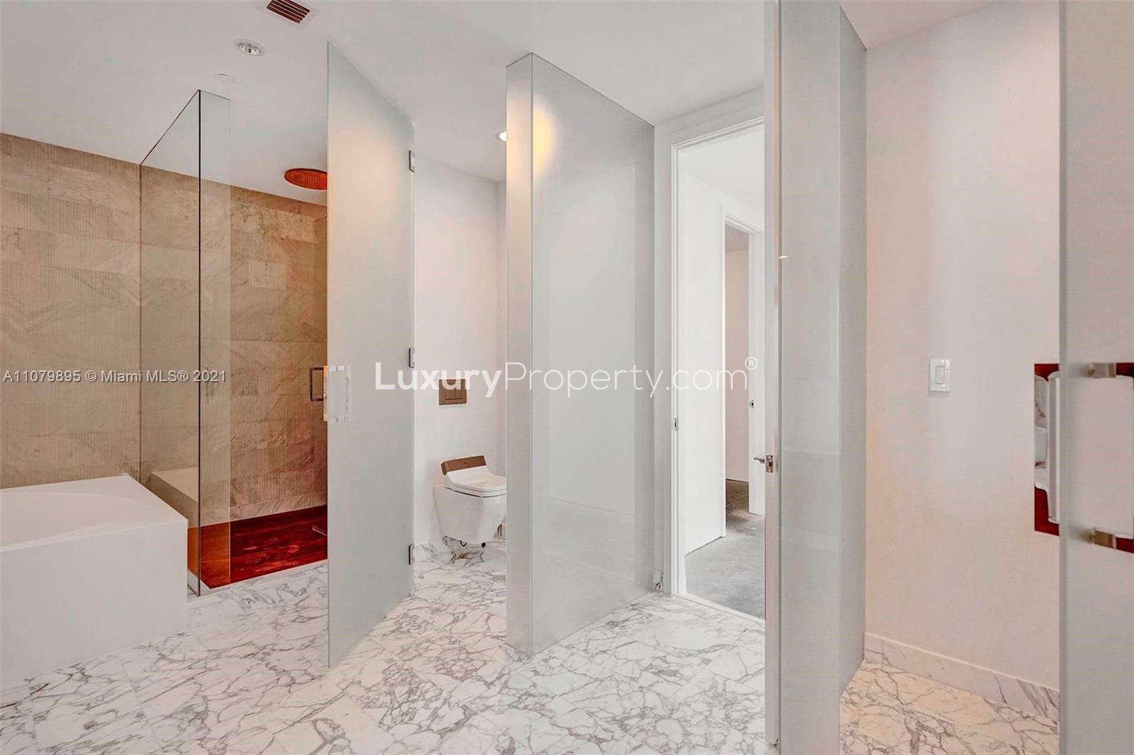 "Spacious hallway in high-floor Bal Harbour condo, Miami villa for sale, Florida.",Luxurious bathroom with marble flooring in high-floor Bal Harbour condo, Miami