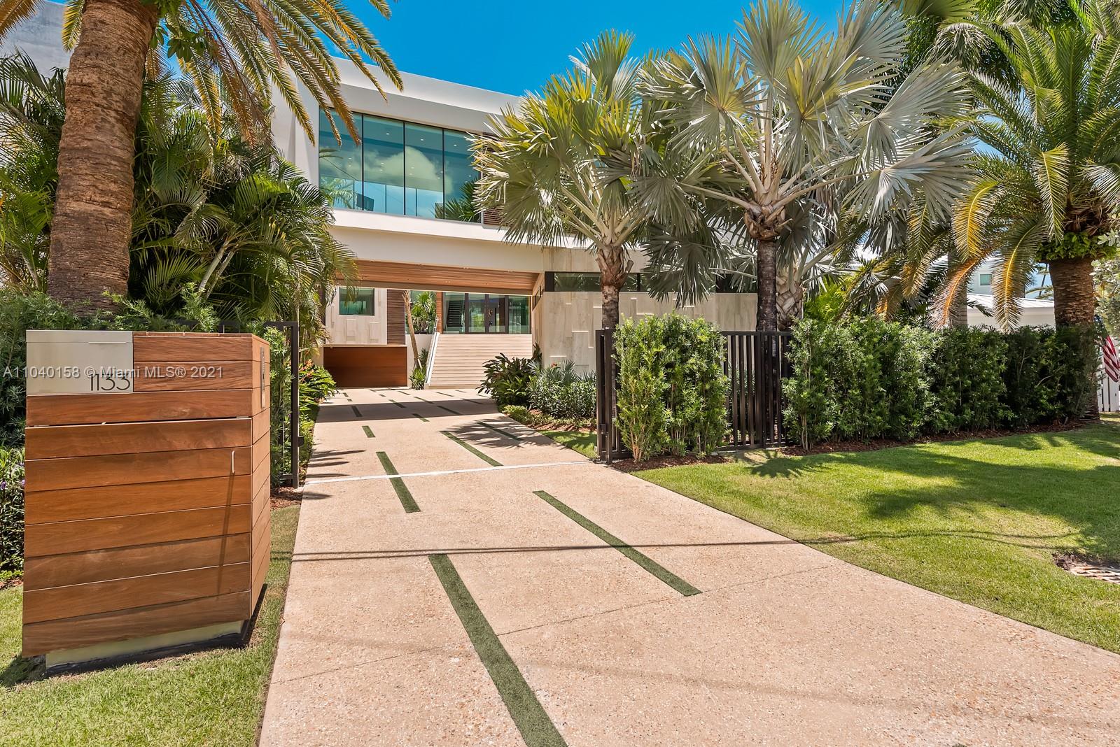 Modern 3-story villa exterior with glass facade in Miami, Florida for sale