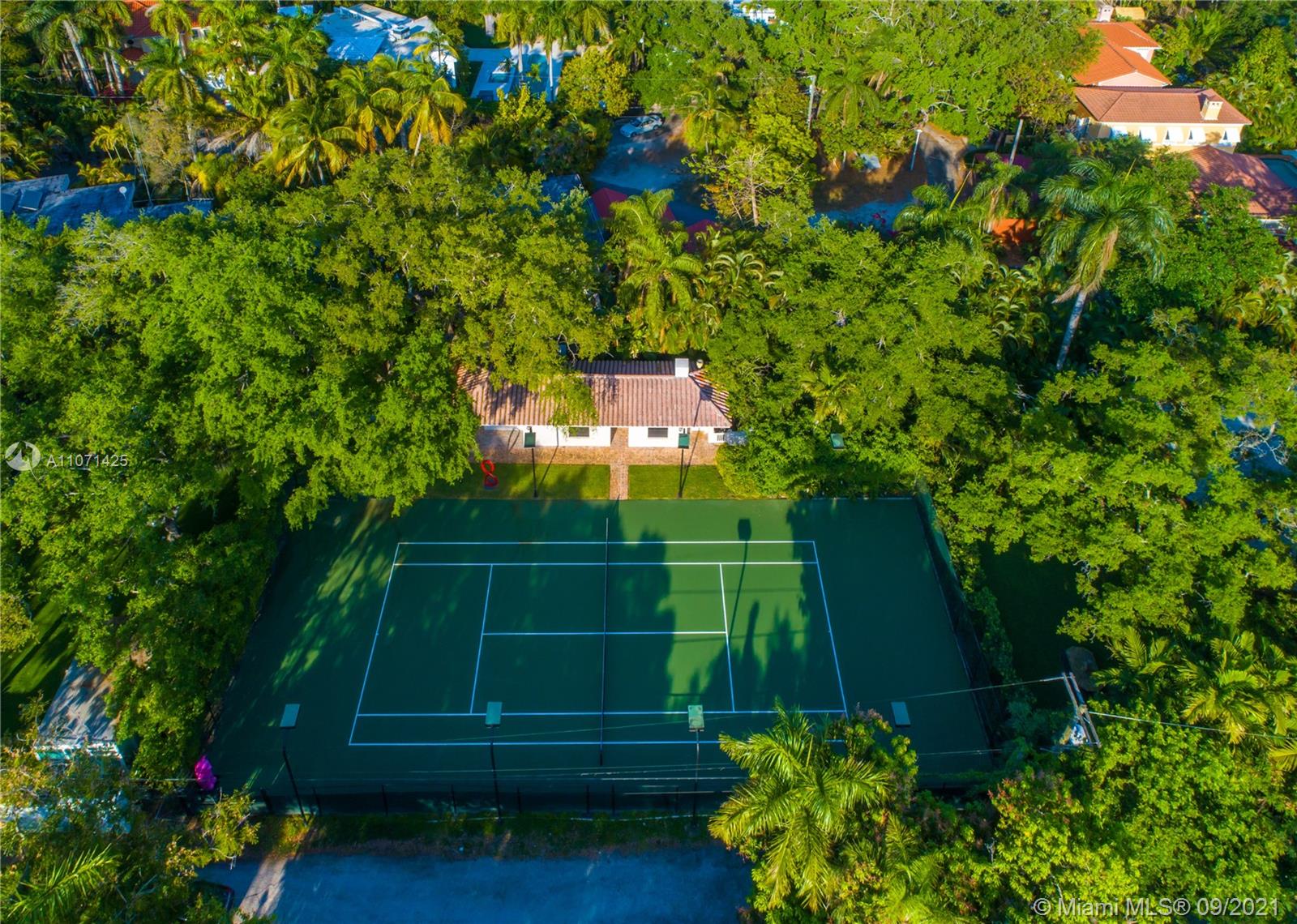 Lush garden with vibrant flowers at Miami villa, 2131 S Bayshore Dr, for sale