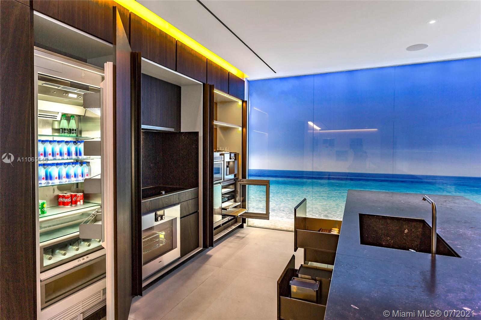 Modern kitchen in six-bedroom Hallandale Beach penthouse with ocean-themed decor and sleek appliances