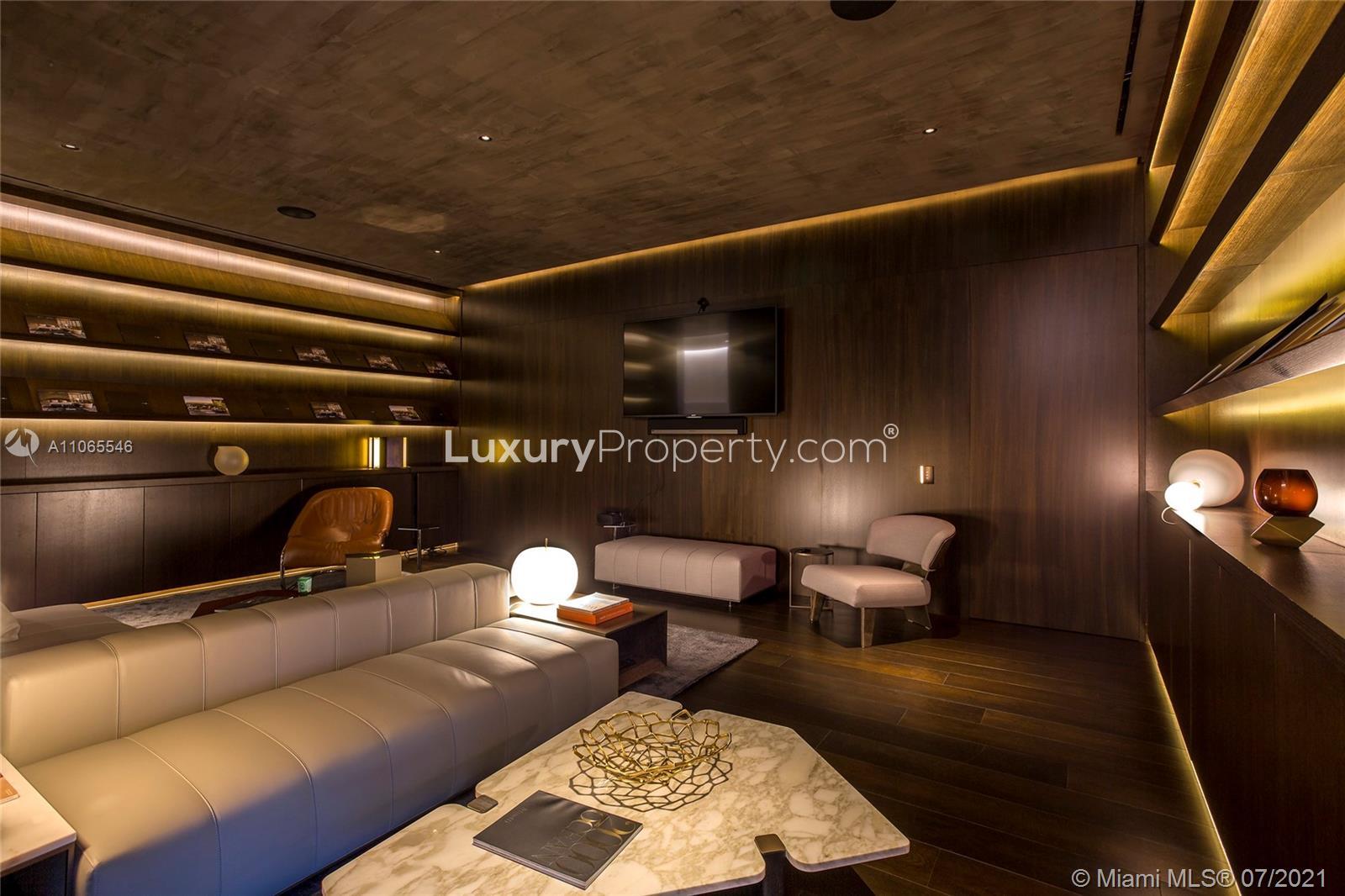 "Modern high-rise exterior view of six-bedroom penthouse in Hallandale Beach, Florida.",Luxurious penthouse living room with modern decor in Hallandale Beach, Florida villa