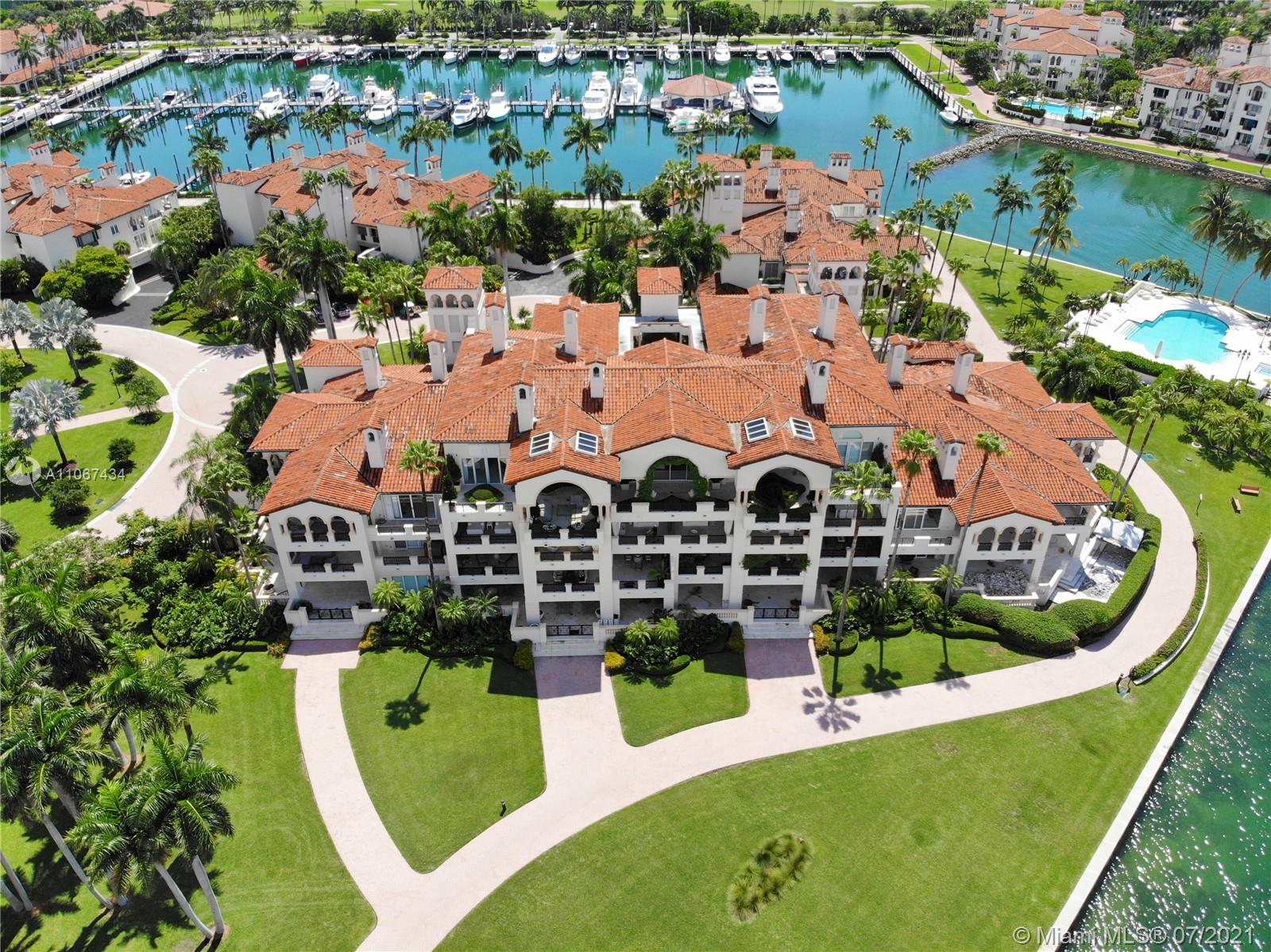 Aerial view of luxurious Miami Beach villa community with marina on Fisher Island