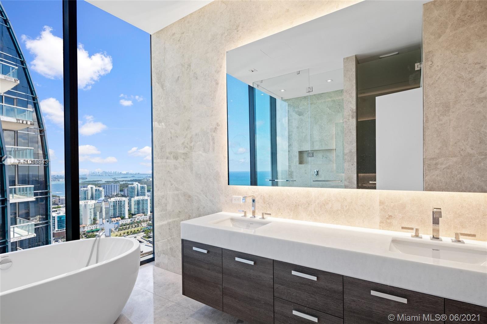Luxury oceanfront villa bathroom with city skyline view, Collins Ave, Miami
