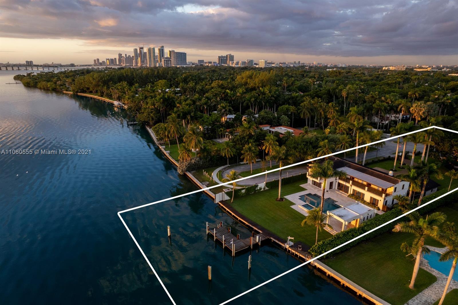 Majestic Miami villa at sunset, waterfront view, lush surroundings, 5 bedrooms, 6 bathrooms
