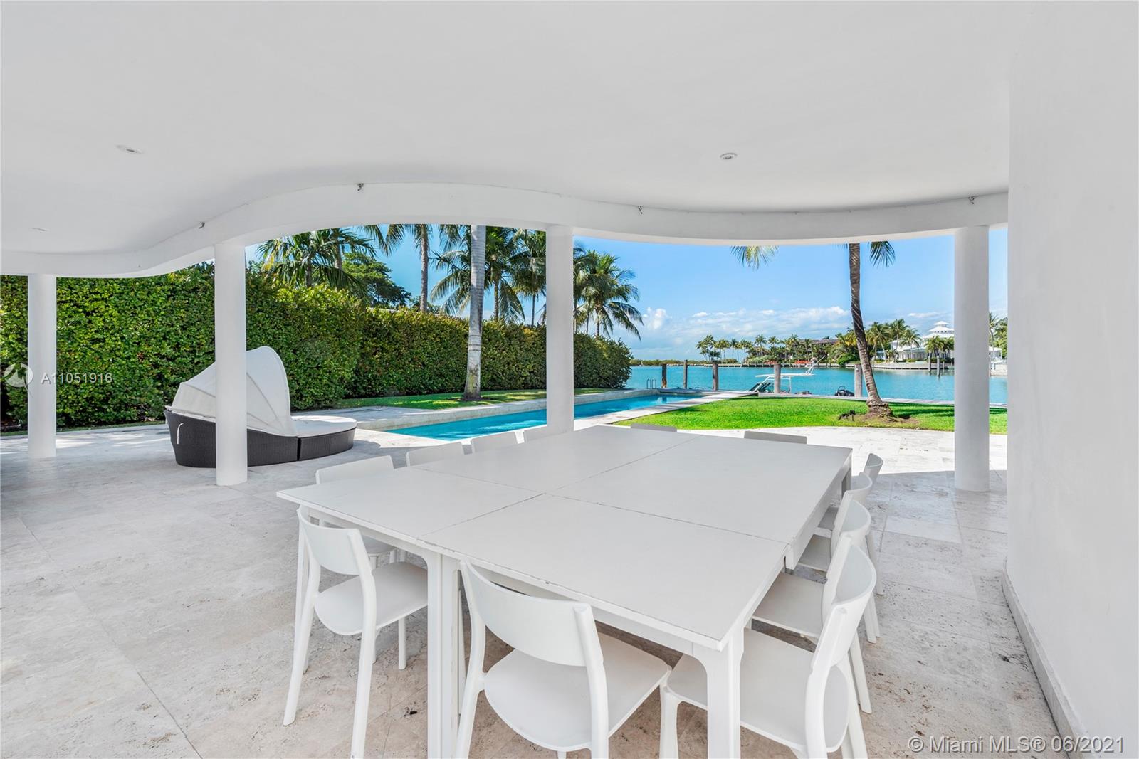 Aerial view of canal-side villas in Key Biscayne, Miami, with city skyline backdrop