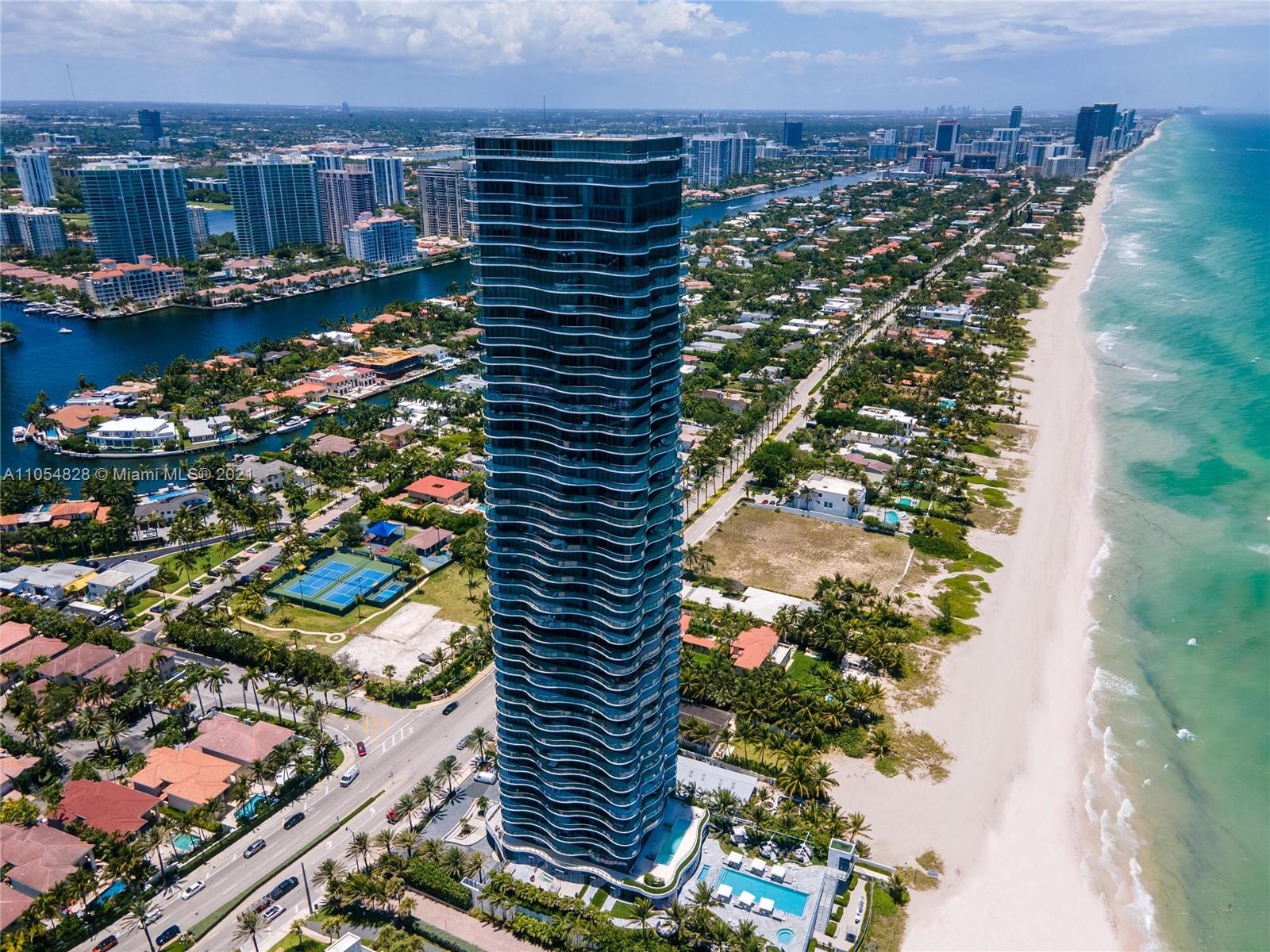 "Stunning oceanview from luxury villa balcony at sunset, Miami, Florida, 19575 Collins Ave.",Aerial view of luxury oceanfront villa at 19575 Collins Ave, Miami, with beach access