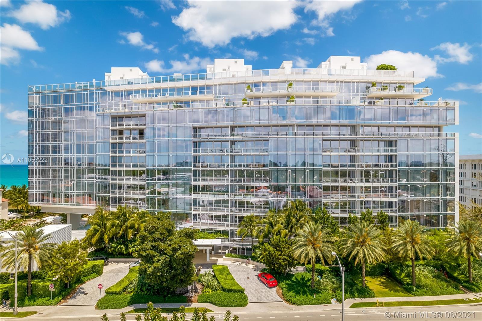 "Spacious balcony with ocean view in Surfside, Miami waterfront villa for sale.",Modern waterfront villa facade in Surfside, Miami with lush landscaping and ocean views