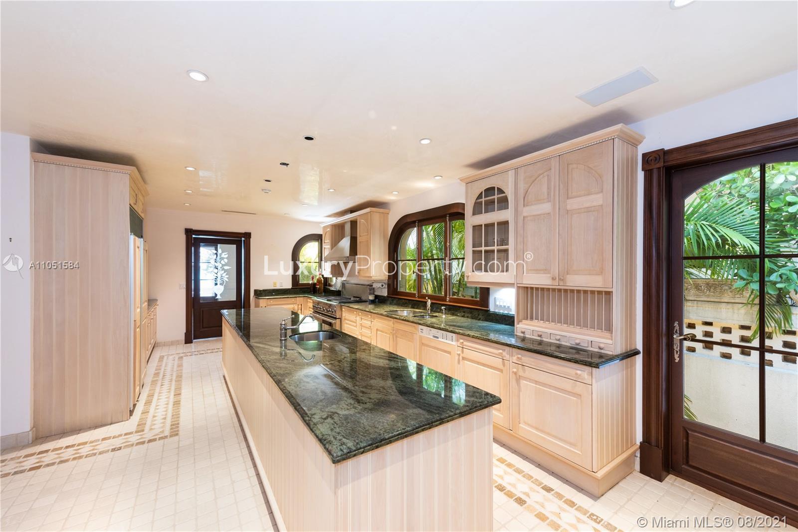 "Charming gated entrance to rustic five-bedroom villa on North Bay Road, Miami Beach.",Luxurious kitchen in rustic five-bedroom villa, North Bay Road, Miami Beach