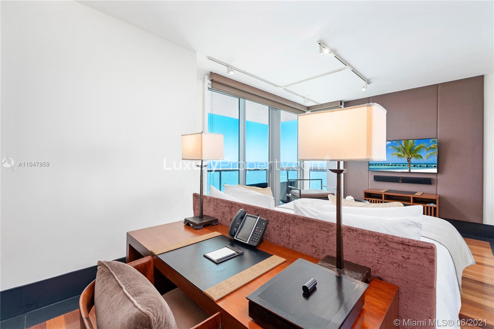 Spacious walk-in closet in Miami villa with modern wooden flooring and ample storage space