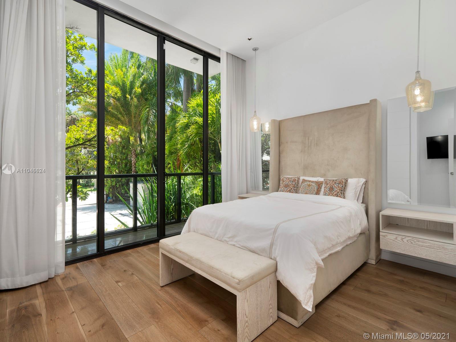 Bright bedroom with floor-to-ceiling windows in Miami Beach villa for sale, LP09814