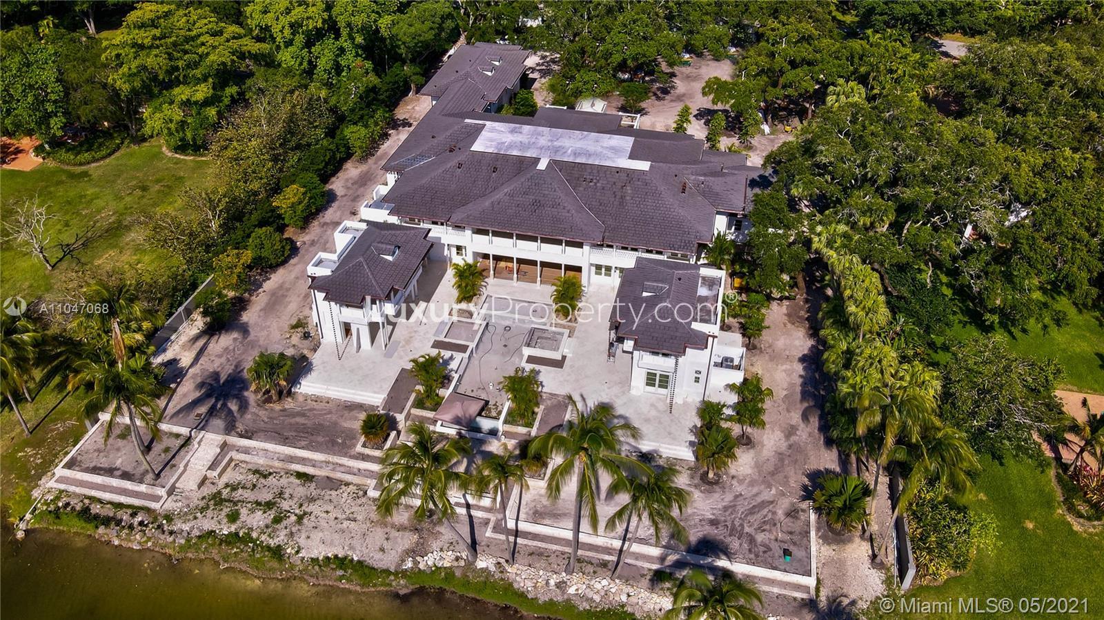 Aerial view of luxurious lakefront villa at 10900 Lakeside Dr, Coral Gables, Miami