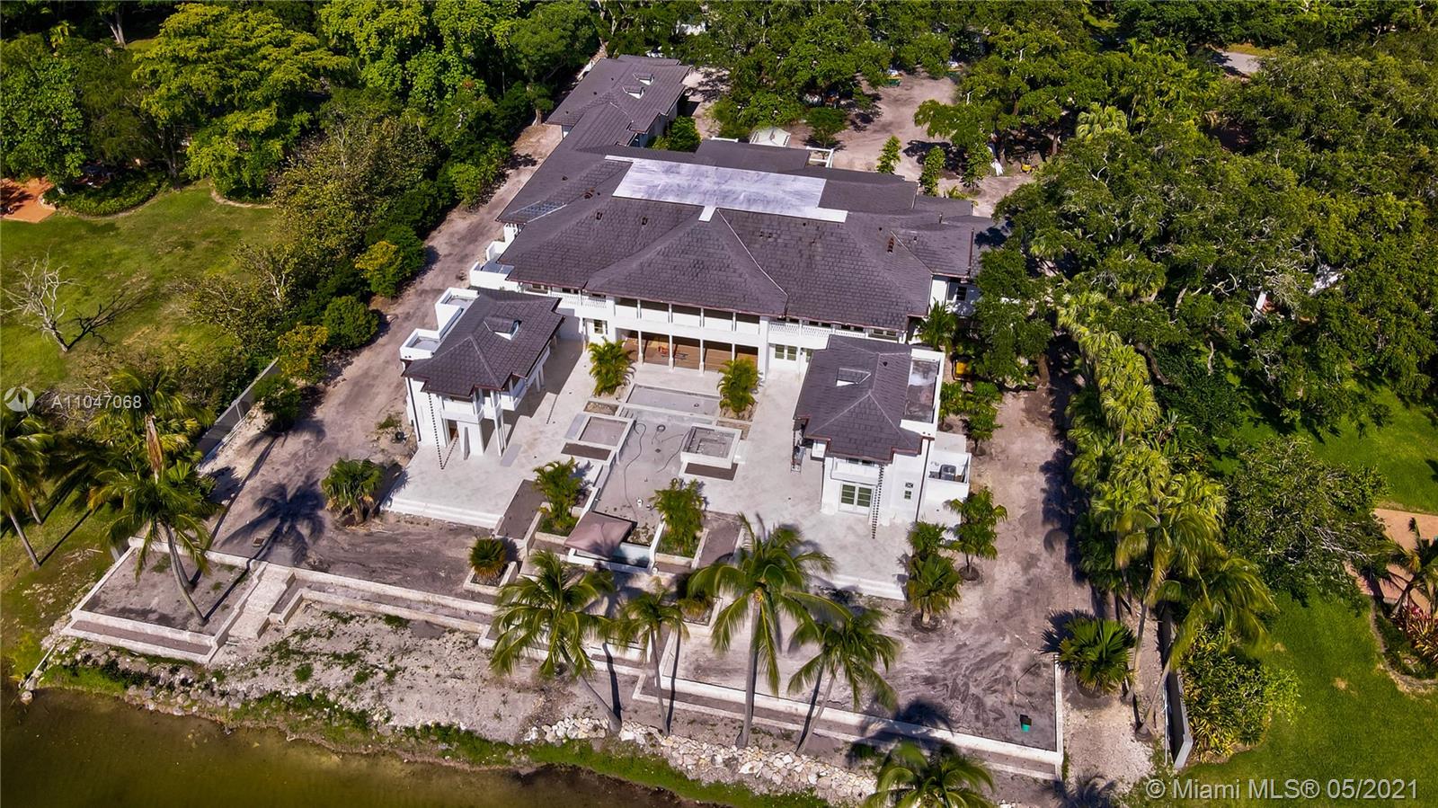 Aerial view of luxurious lakefront villa at 10900 Lakeside Dr, Coral Gables, Miami