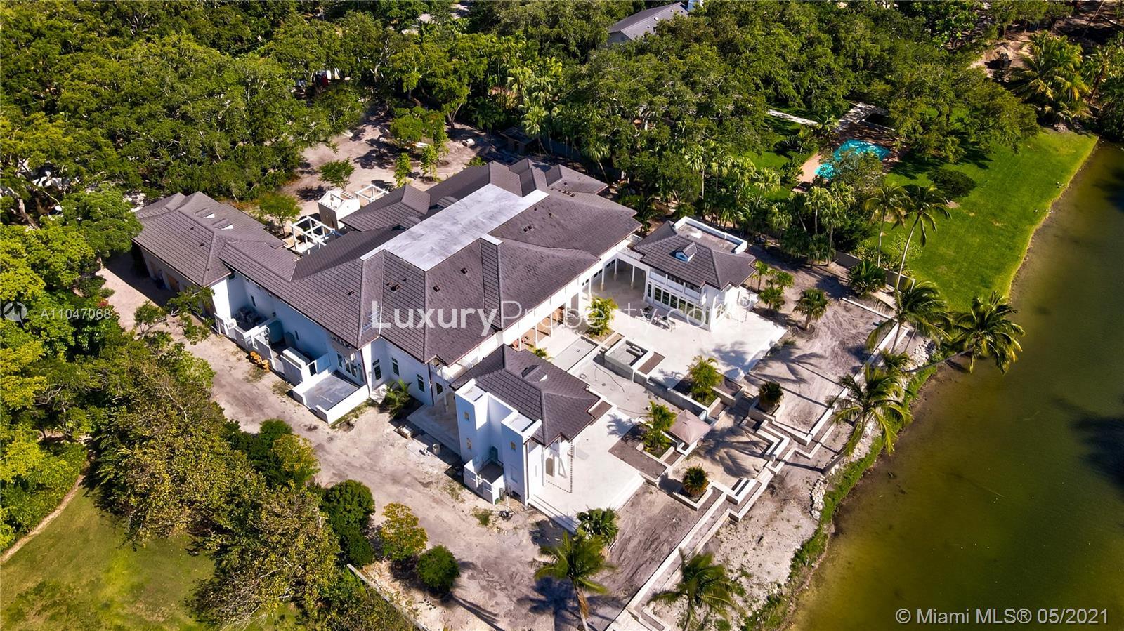 Aerial view of lakefront villa at 10900 Lakeside Dr, Coral Gables, Miami for sale