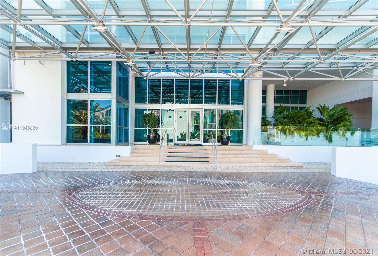 Aerial view of Miami beachfront buildings near 5959 Collins Ave, showcasing ocean and skyline