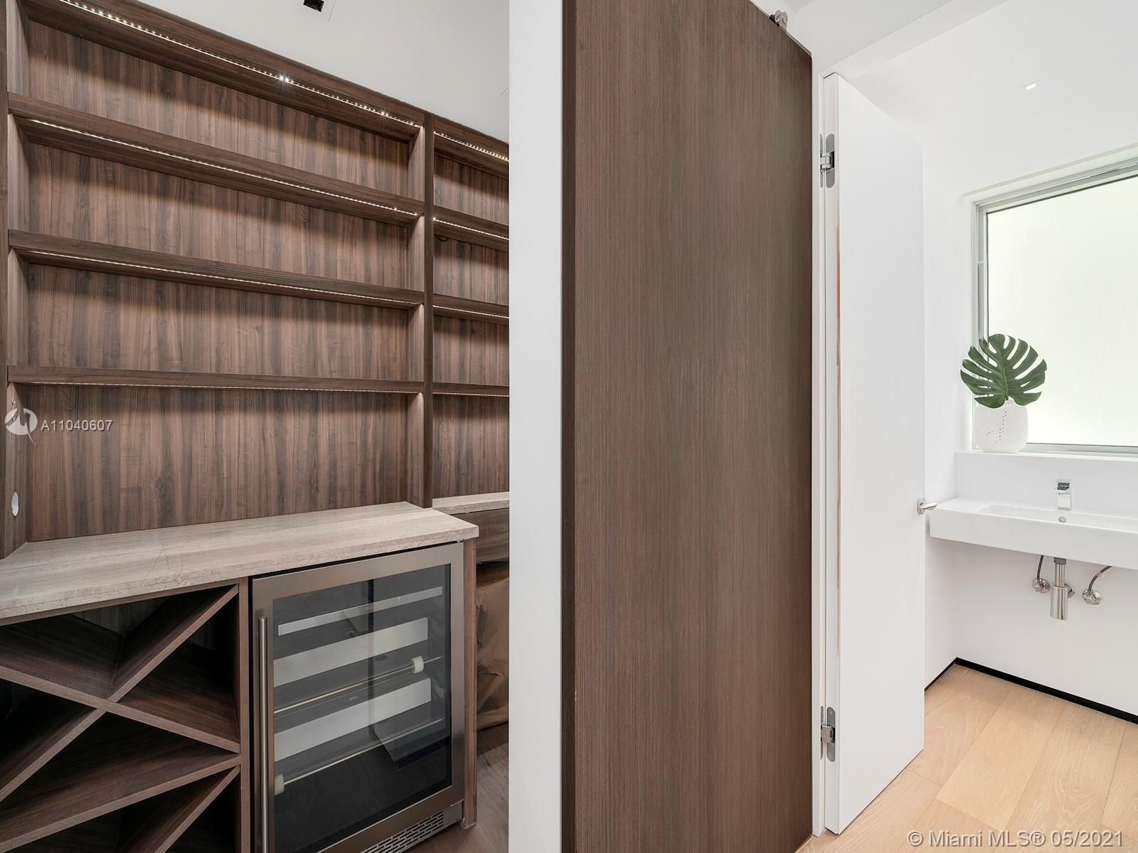 Luxurious Miami villa balcony with ocean view, modern furniture, and lush greenery