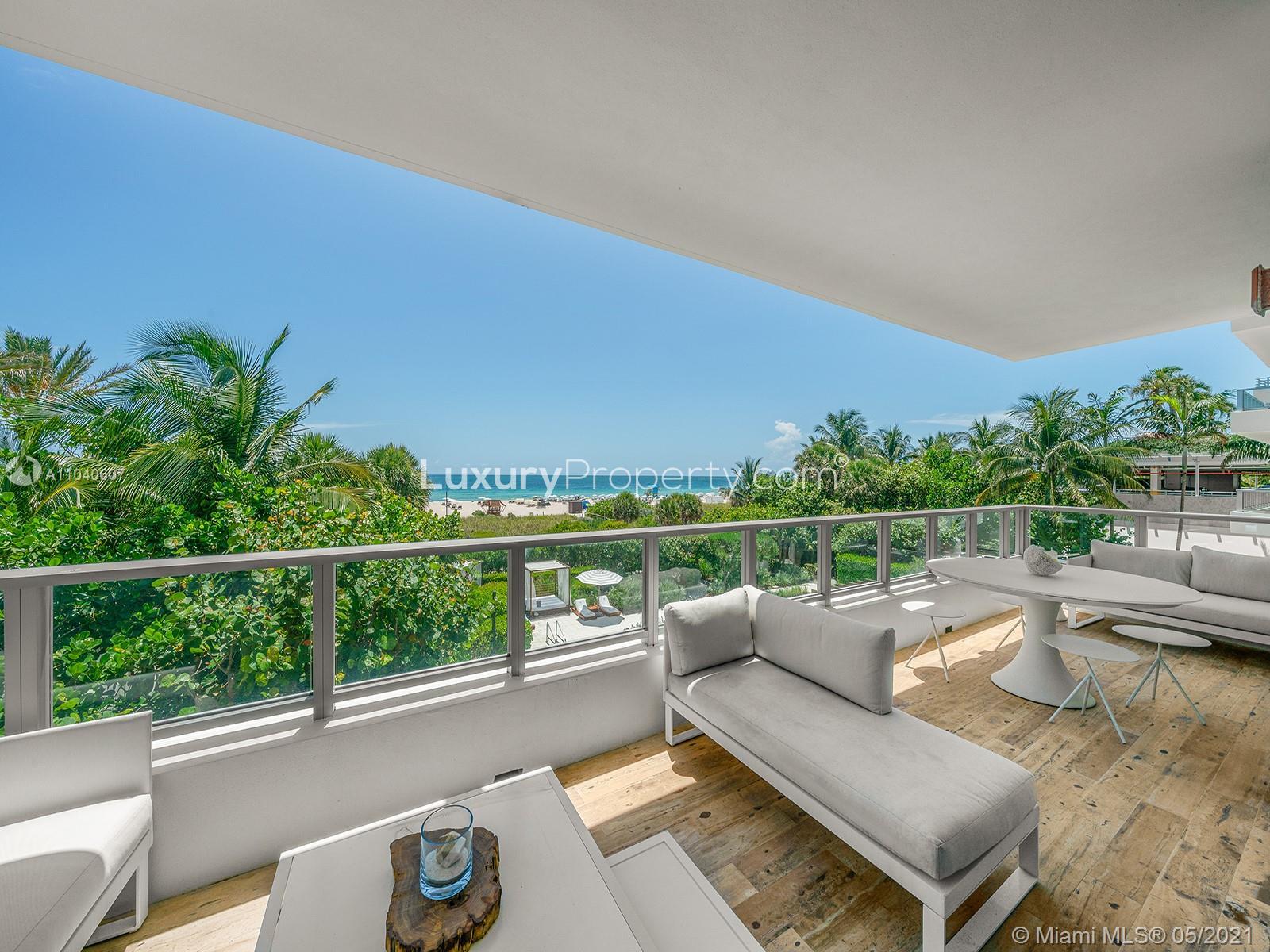Luxurious open-plan living area in Miami villa with ocean views, modern decor, and bar