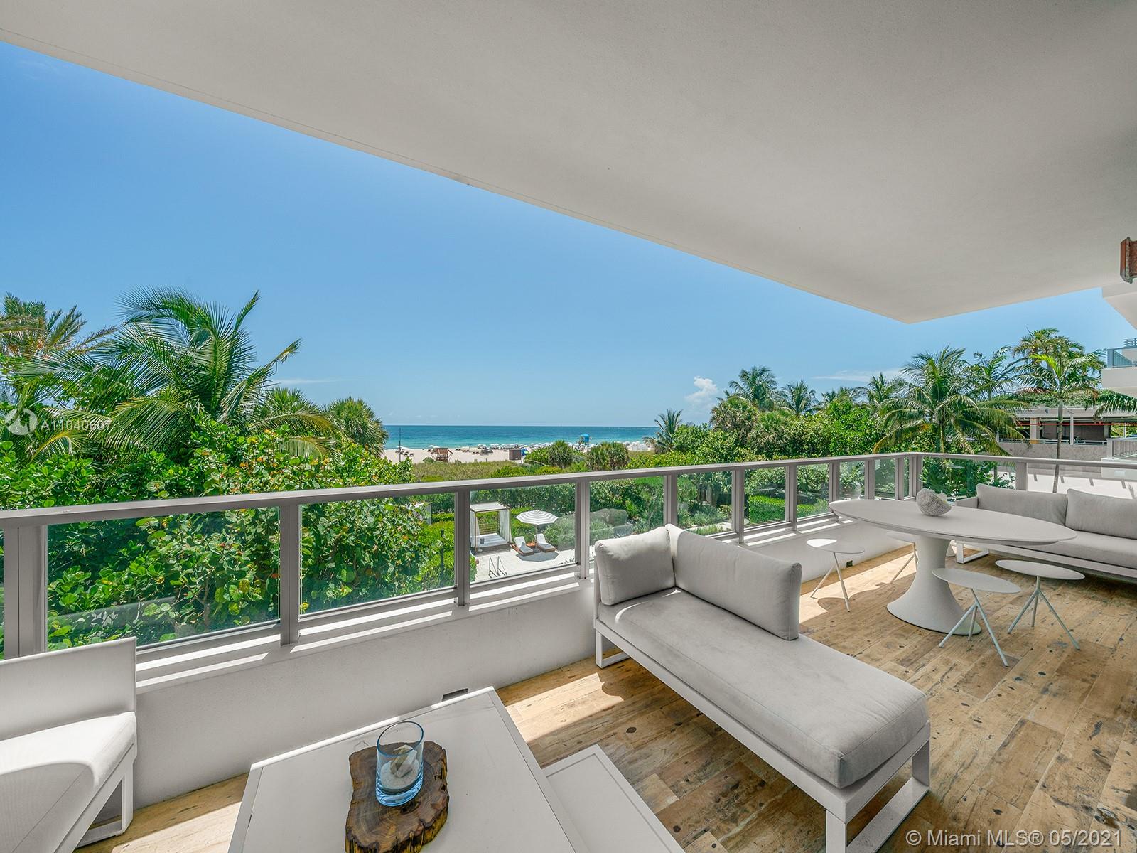 Luxurious open-plan living area in Miami villa with ocean views, modern decor, and bar