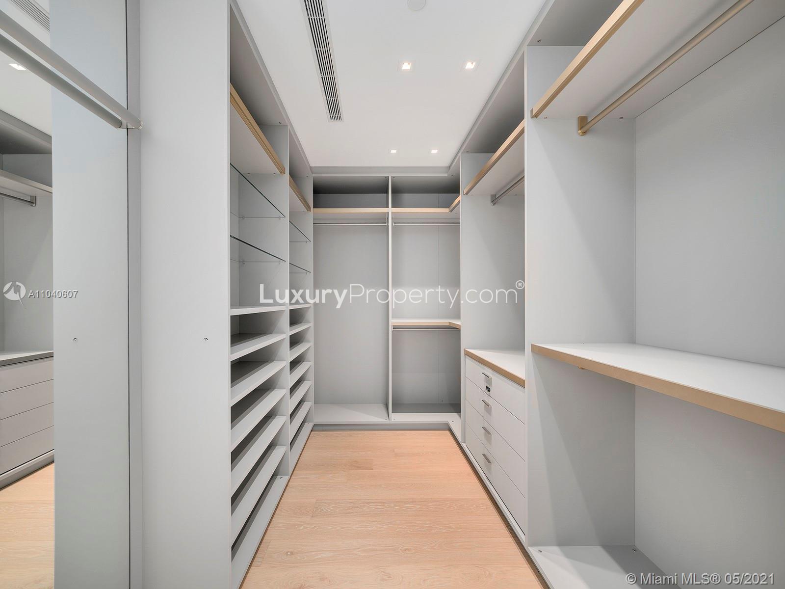 Modern wine storage and bathroom in Miami villa for sale, 125 Ocean Dr, Florida