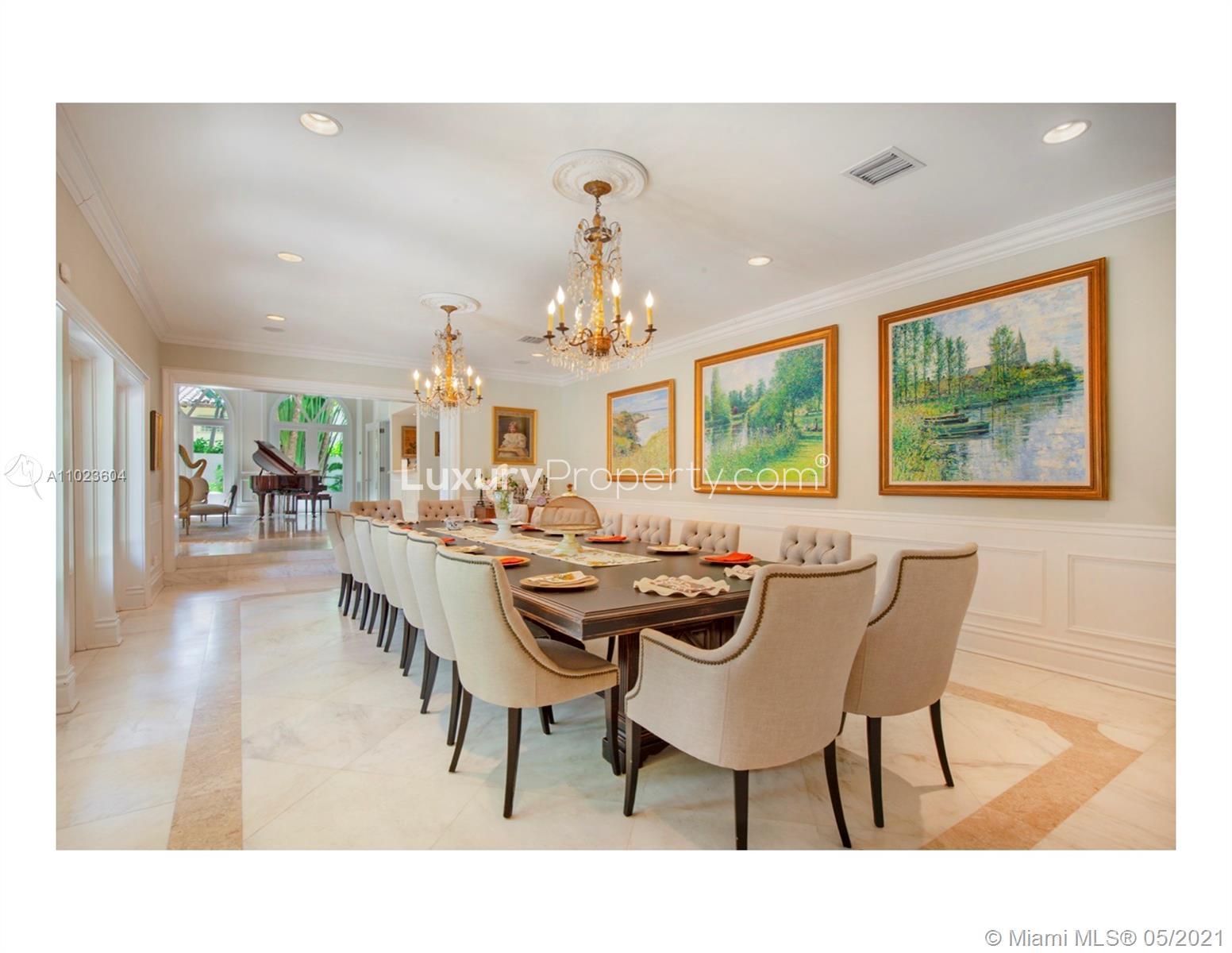 Tropical entrance of five-bedroom villa on Bayshore Drive, Miami Beach, surrounded by lush greenery