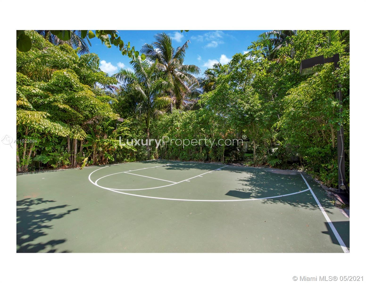 Luxurious Miami Beach villa with private pool, elegant patio, and tropical landscaping