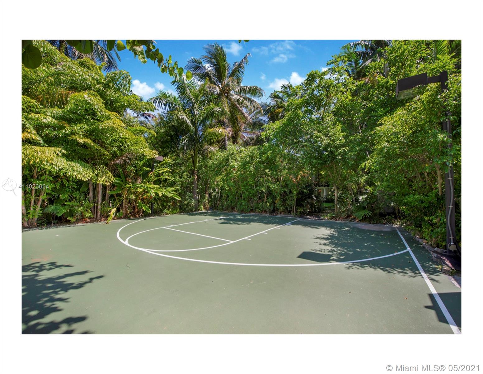 Luxurious Miami Beach villa with private pool, elegant patio, and tropical landscaping