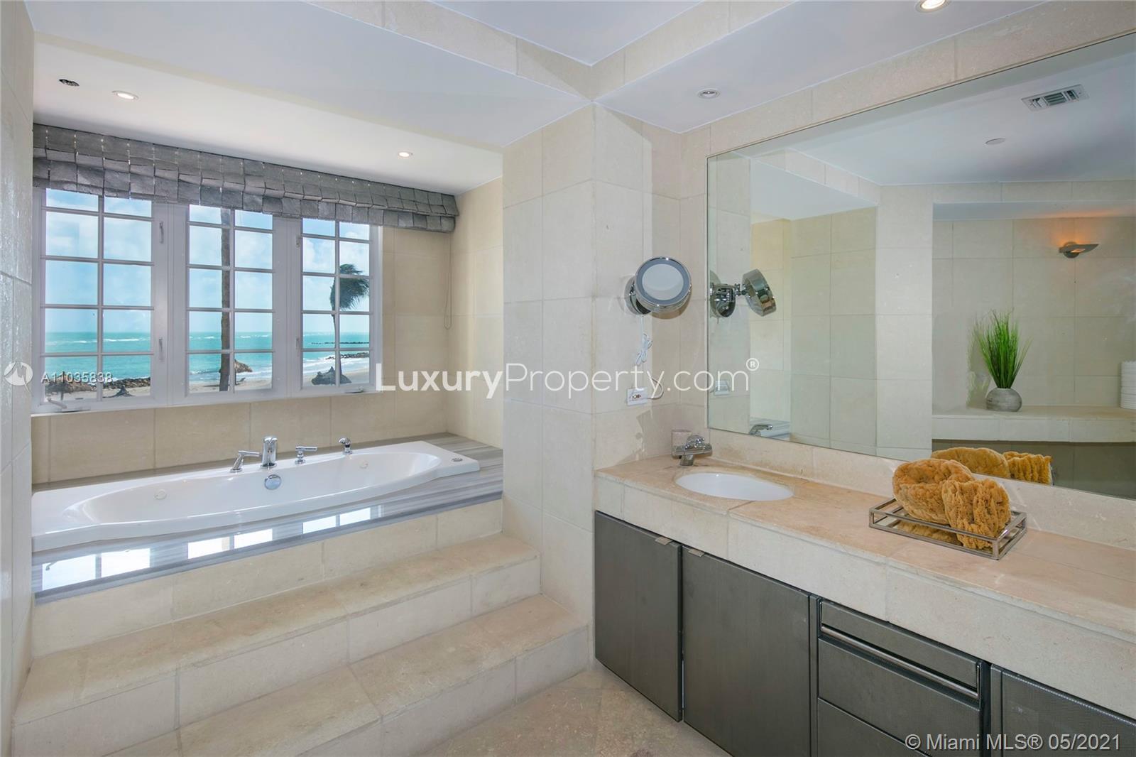Luxury closet in oceanfront villa, Fisher Island, Miami, with mirrored doors and ample storage