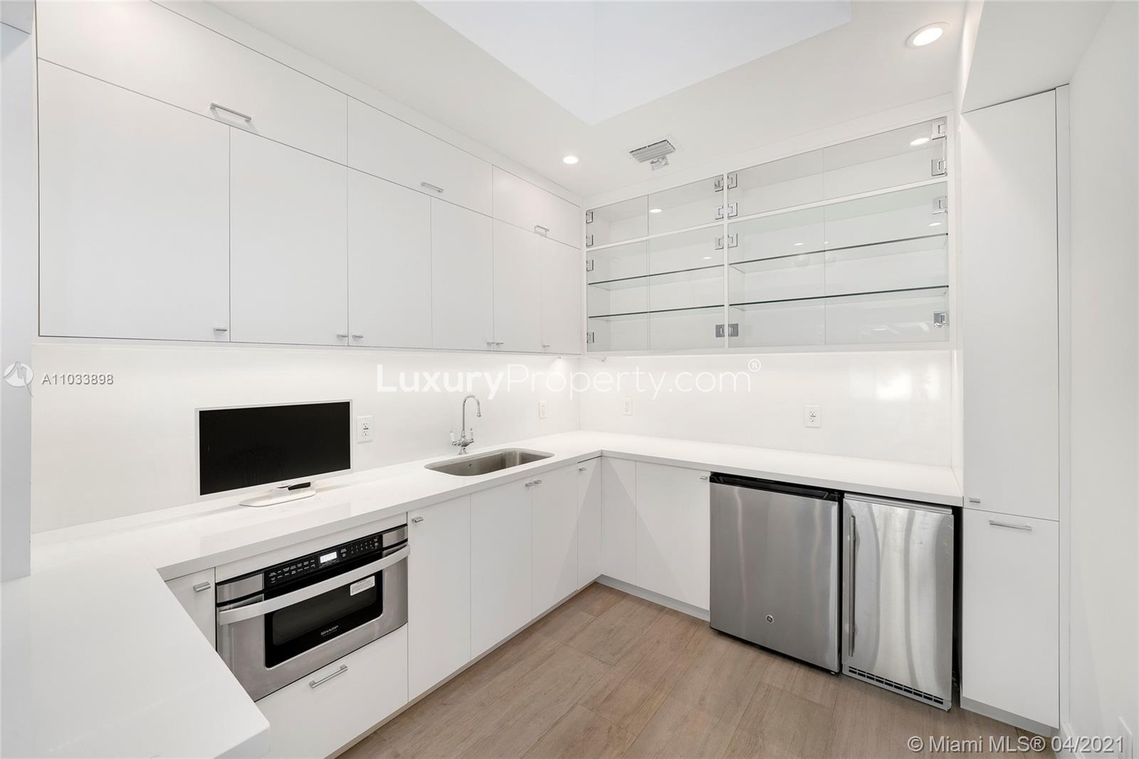 Spacious interior of Miami Beach villa with modern decor and elegant chandelier