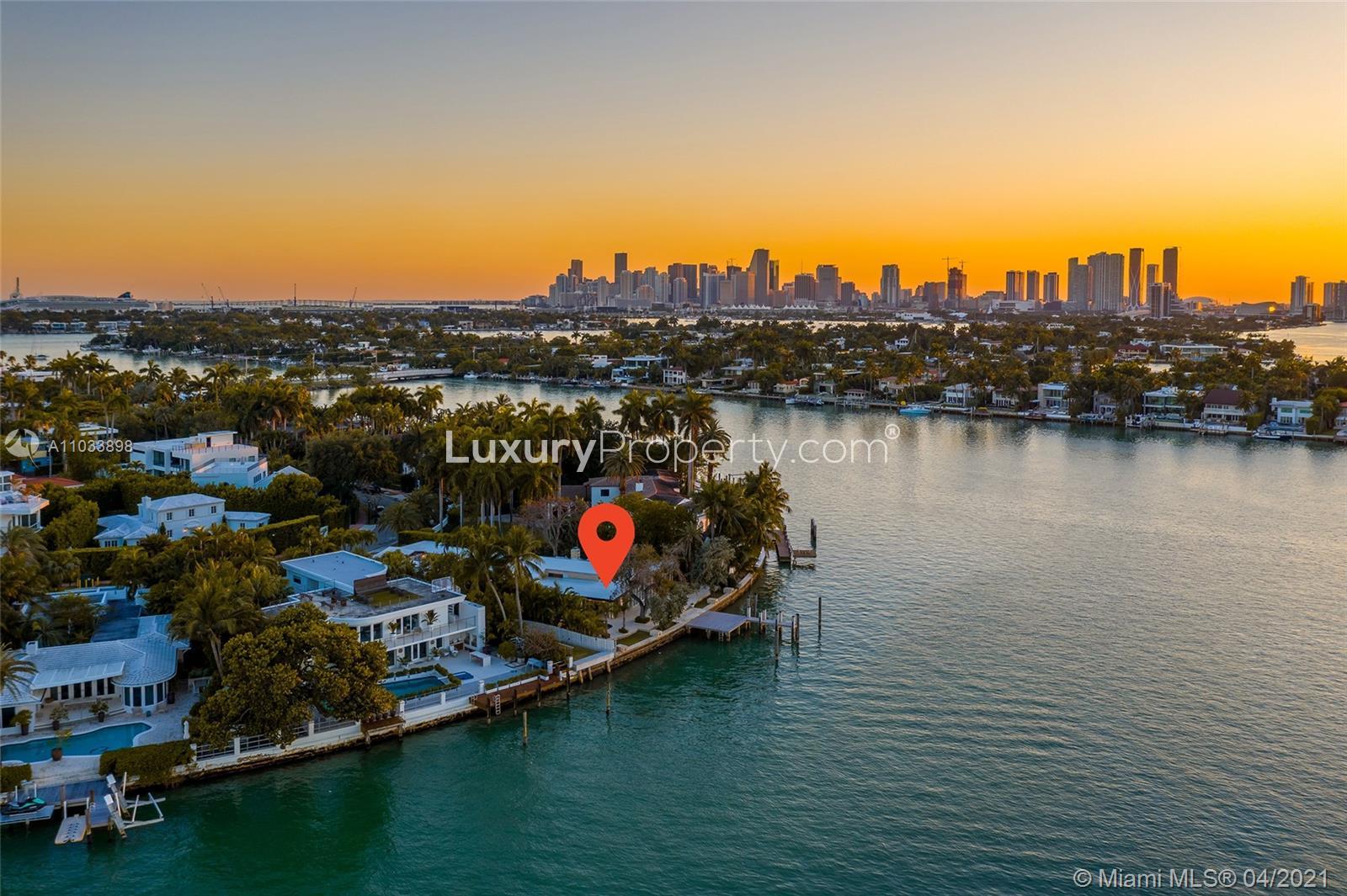 Modern kitchen in Sunset View Villa, Miami Beach, with sleek white cabinetry and appliances