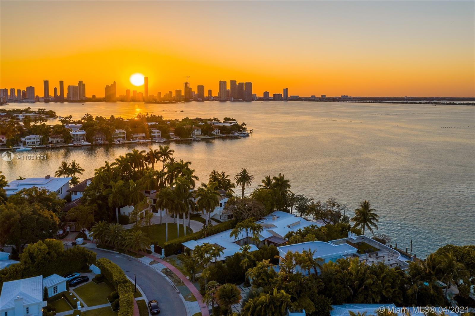 Aerial view of bayfront villa for sale in Miami, Florida at sunset