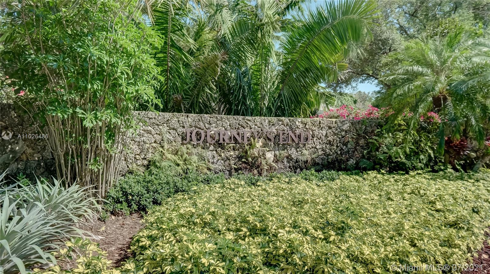 Gated entrance of luxurious seven-bed villa in Coral Gables, Miami, surrounded by lush greenery