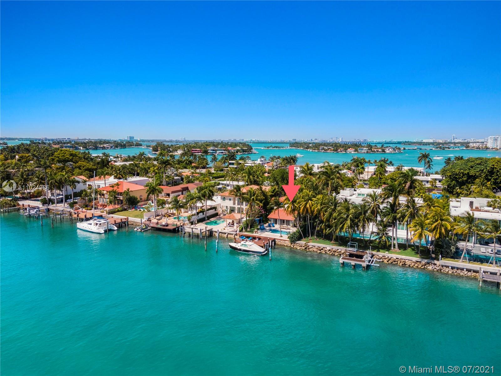 "Waterfront villa with boat dock at 56 S Hibiscus Dr, Miami Beach, for sale.",Aerial view of waterfront villa for sale in Miami Beach, Florida with lush surroundings