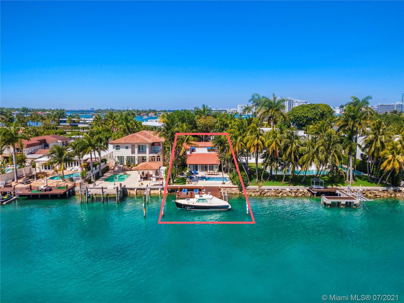 Waterfront villa view with private dock and boat at Miami Beach, Florida