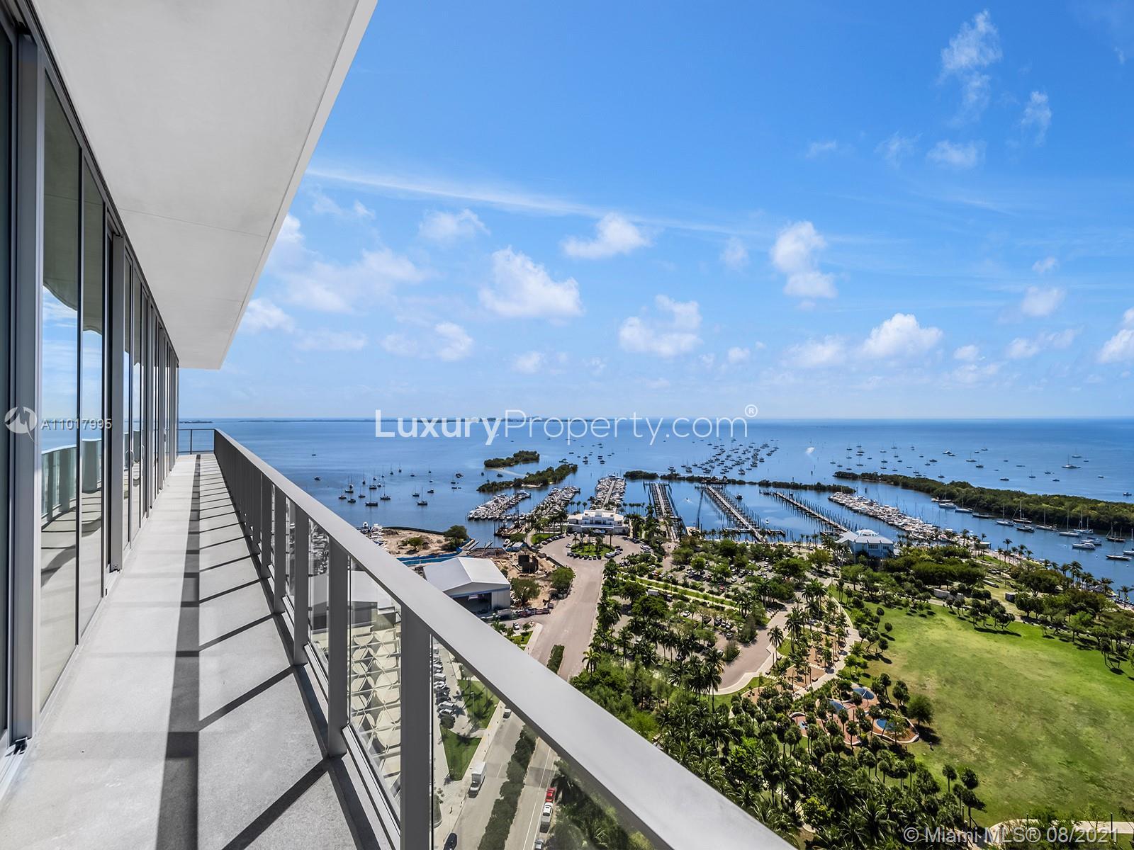"Penthouse balcony with stunning ocean view at 2675 S Bayshore Dr, Miami villa for sale.",Penthouse balcony view of marina and ocean at 2675 S Bayshore Dr, Miami, Florida