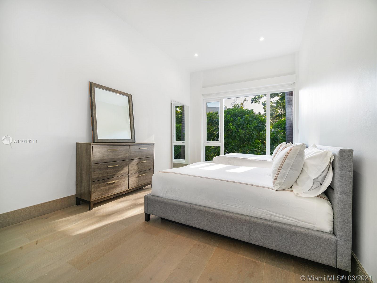 Aerial view of luxury Miami villa with skyline and waterfront at 24 Palm Ave