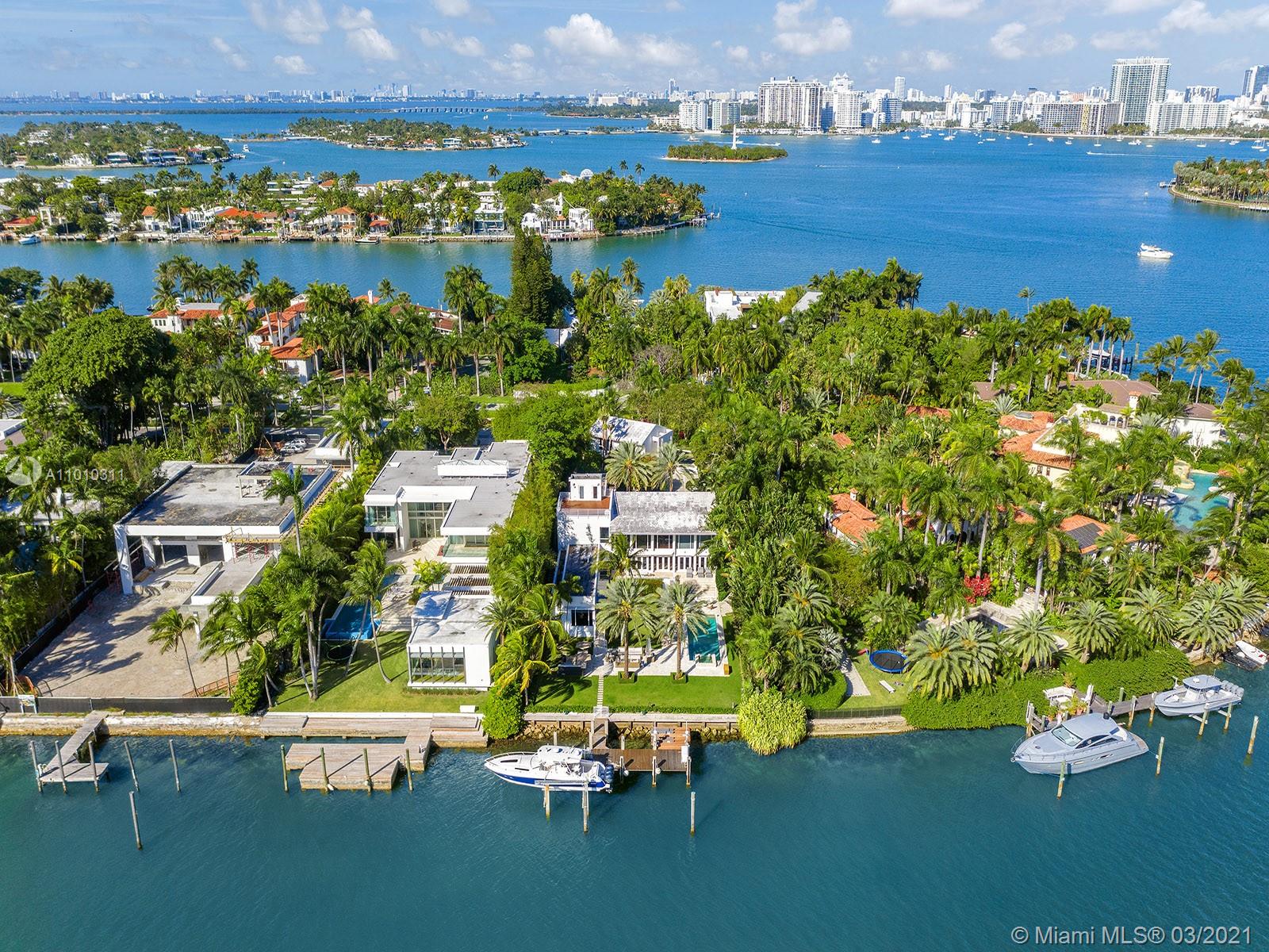 Miami estate with skyline view, lush greenery, and nearby waterfront featuring a cruise ship