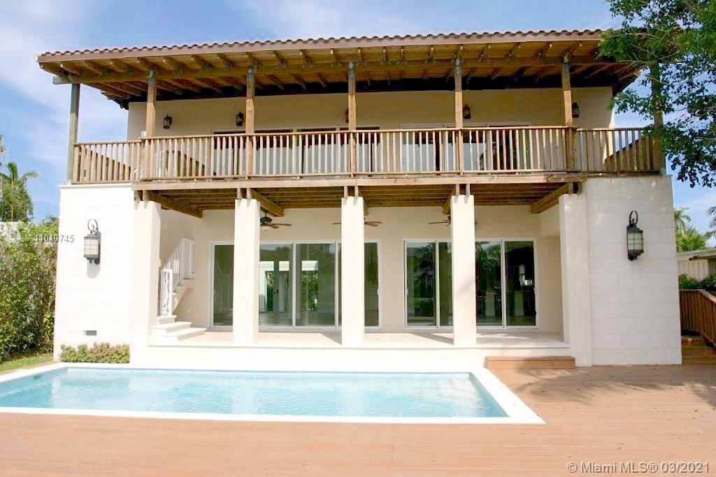 Spacious wooden balcony with lush garden view in Miami Beach villa for sale