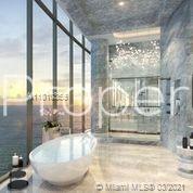 Luxurious Miami oceanfront villa living room with panoramic views, modern decor, and natural light