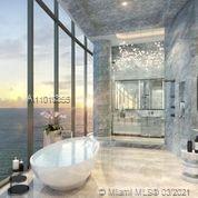 Luxurious Miami oceanfront villa living room with panoramic views, modern decor, and natural light