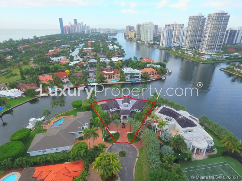 Luxurious waterfront villa with palm trees, Golden Beach, Florida, spacious architecture, for sale