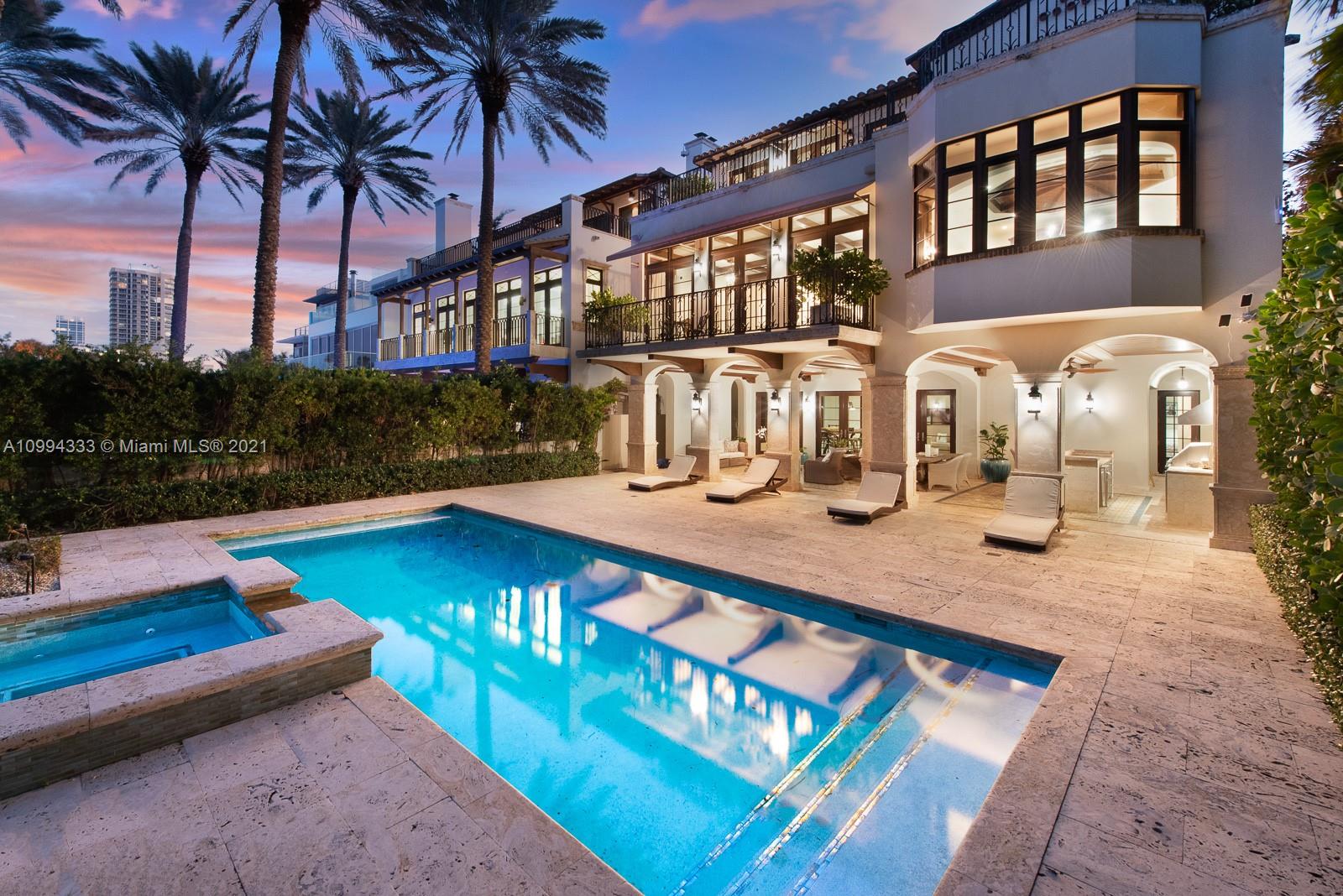 Spanish Mediterranean villa with pool at dusk, 7737 Atlantic Way, Miami, for sale