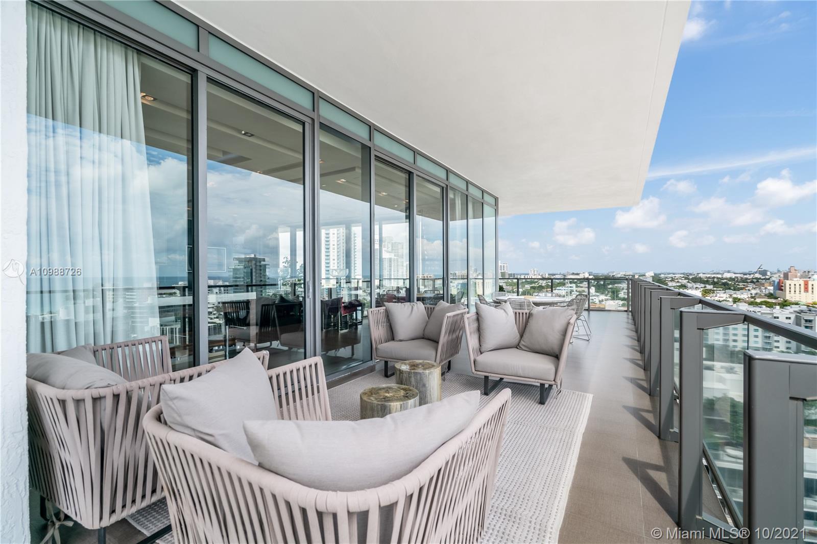 Luxurious high-floor Miami Beach condo terrace with panoramic views and modern design