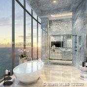 Luxurious Miami villa living room with ocean view, elegant furnishings, and modern decor