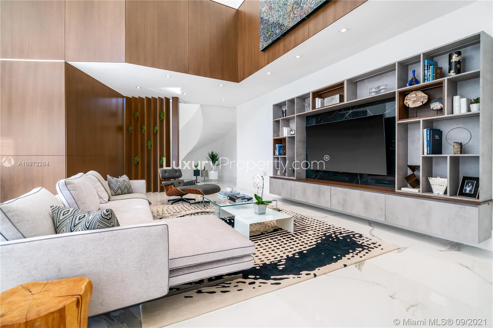 Waterfront villa with yachts, palm trees, and modern architecture at Sunrise Ct, Coral Gables