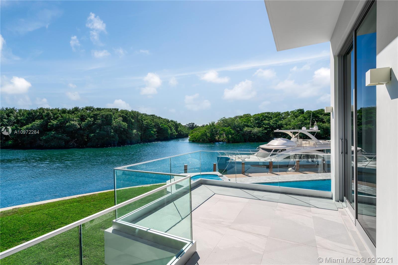 Luxurious living room in waterfront villa, Coral Gables, with modern decor and entertainment center