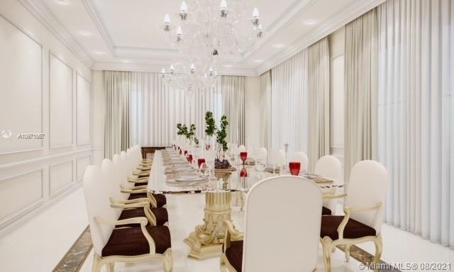 Elegant dining room in a luxury Miami villa for sale, featuring chandeliers and a long table