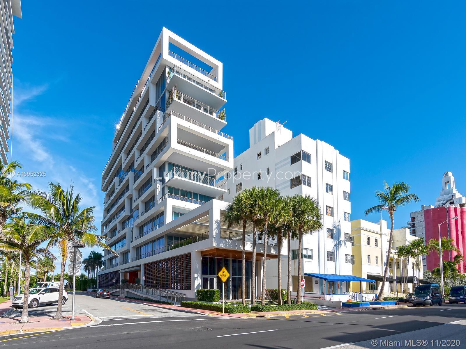 Modern Miami Beach villa exterior with palm trees, showcasing luxury architecture and urban surroundings