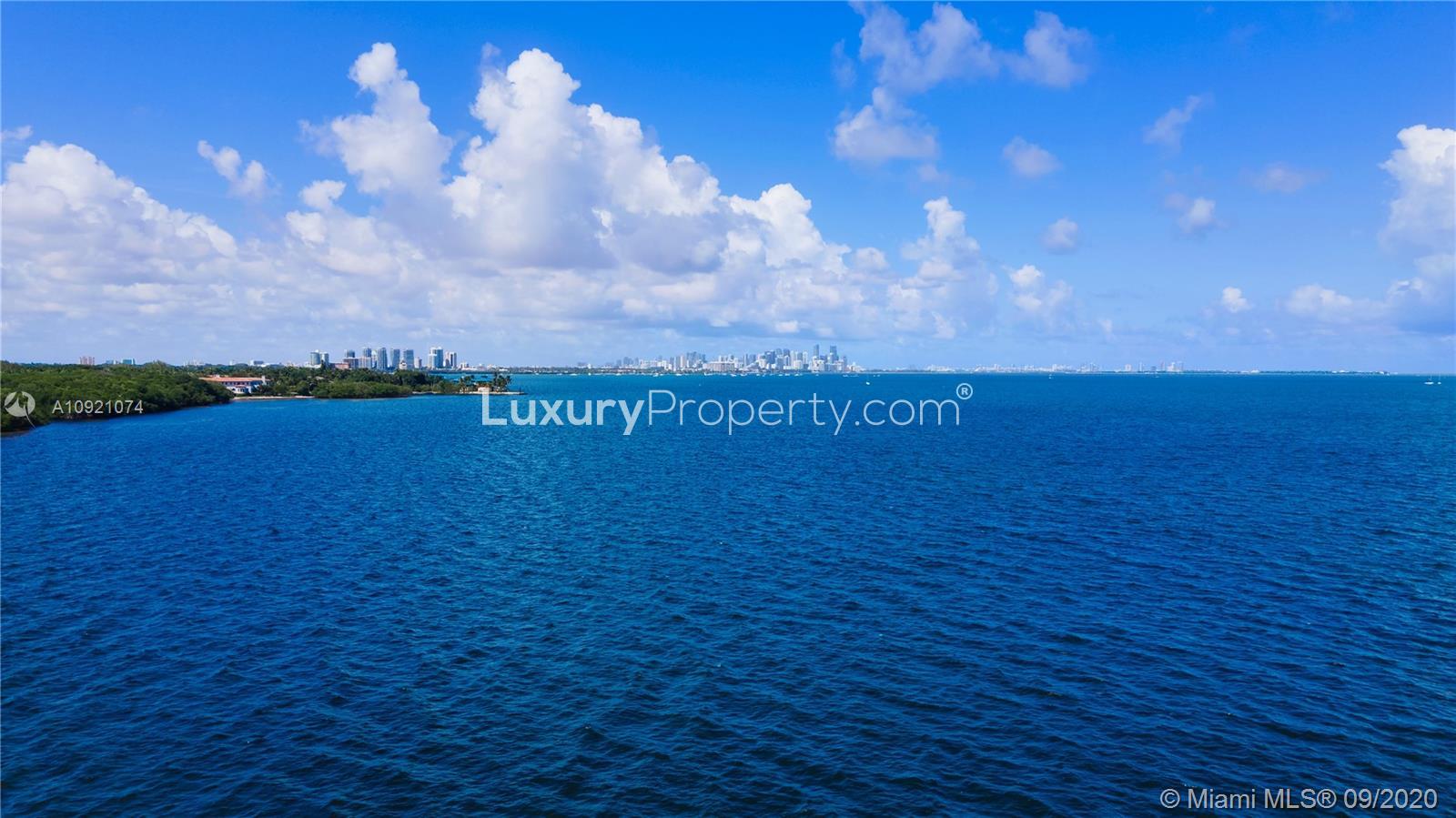 Luxurious Miami waterfront villa with pool at sunset, 41 Arvida Parkway