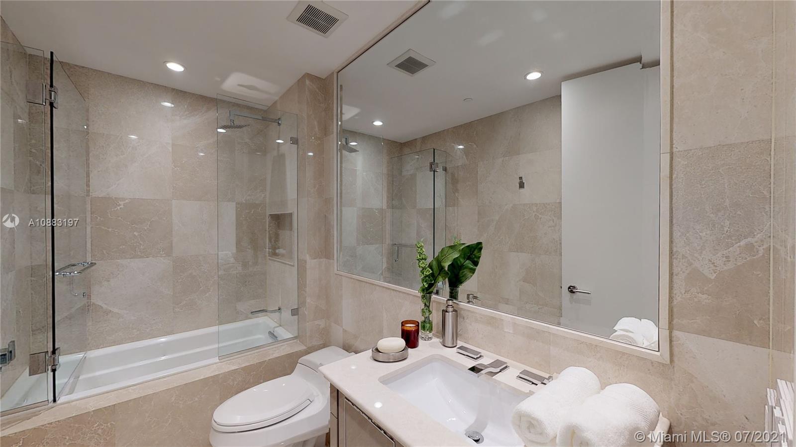 Fully furnished bedroom with ocean view in Miami villa at 9349 Collins Ave