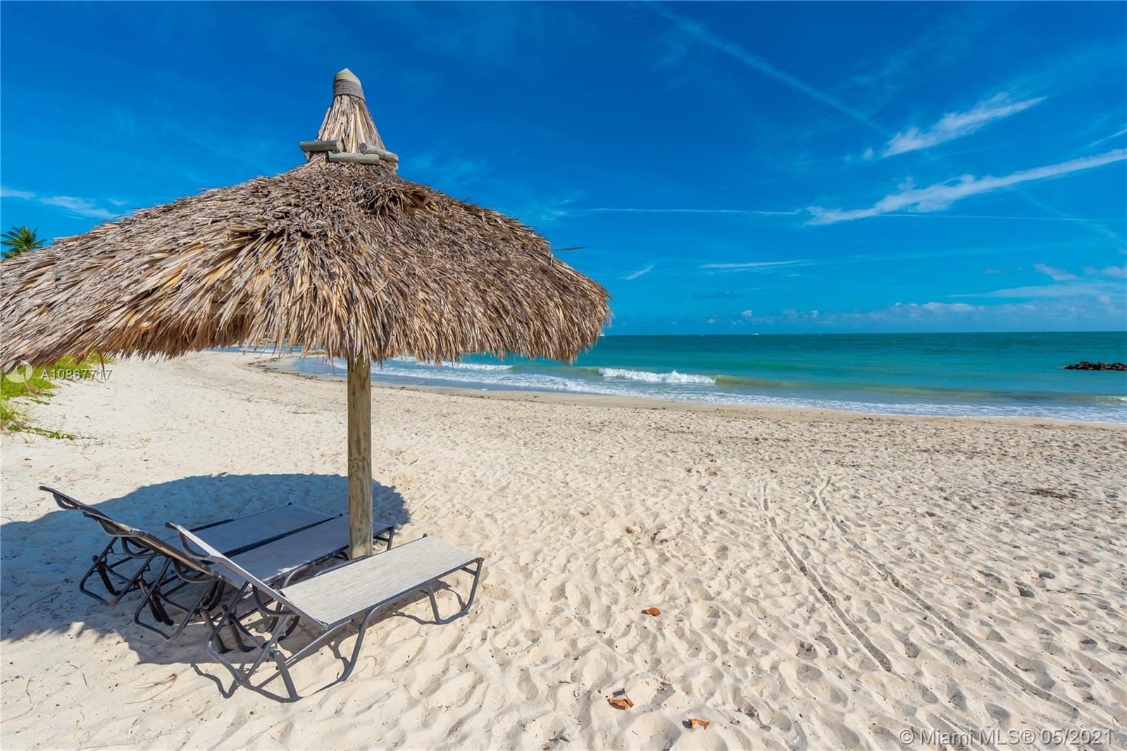 Aerial view of luxury Miami Beach villa, golf course, and water feature, Florida community
