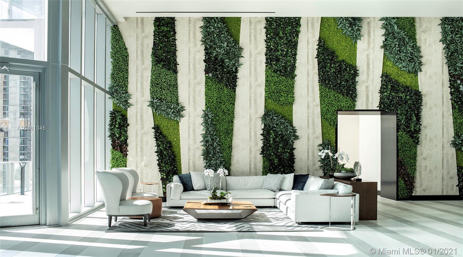 "Luxury Miami villa squash court with glass walls, 5 bed, 6 bath, for sale.",Luxurious living room with modern decor and green vertical garden in Miami villa